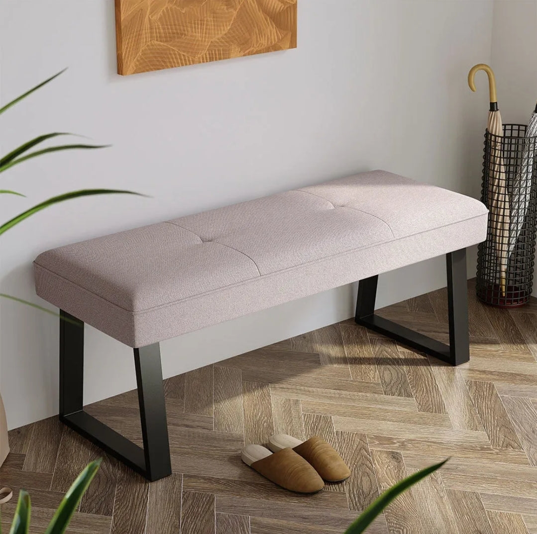 Upholstered bench with trapezium metal legs